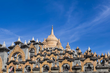 Fototapeta na wymiar Sandstone pagoda in wat Pa Kung temple at Roi Et of Thailand on blue sky