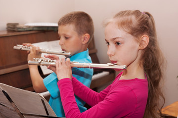 a boy and a girl playing the flute