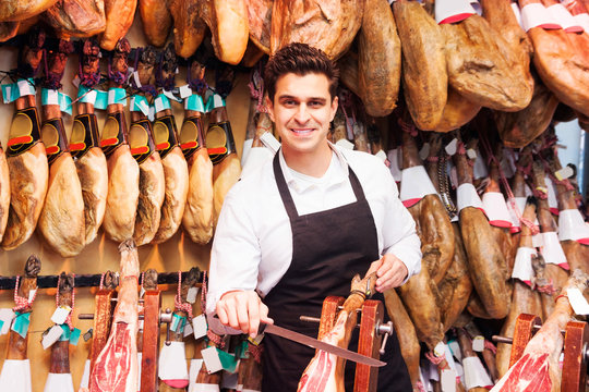 guy in a shop selling jamon