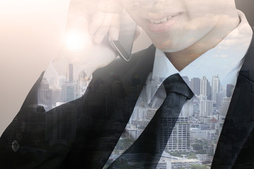 businessman talking on the phone with city background