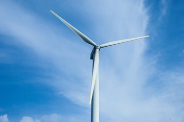 Wind turbines generating electricity on the blue skie