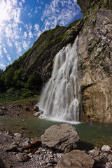 Huge Gegsky waterfall flowing from the cliff. Abkhazia