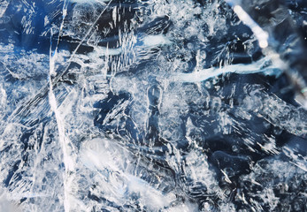 the transparent blue surface of ice speckled with white cracks
