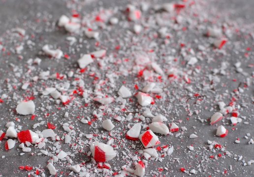 Crushed Peppermint Candy Cane Bits Sprinkled On Wax Paper Background