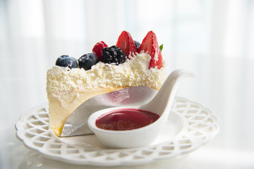 Cheese cake topped with mix berries and strawberry flavour 