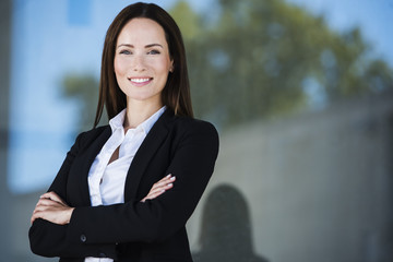 Business woman with crossed arms smiling. With copy space.