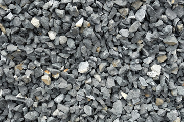 stone aggregate - a stack of gray gravel, coarse loose stones with very irregular shapes, crushed...