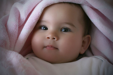 pretty little girl in a pink blanket