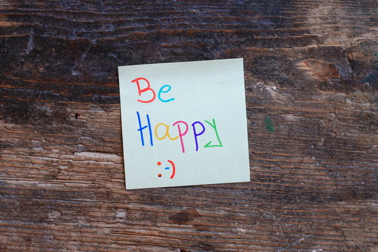 Motivation message Be happy on wooden table