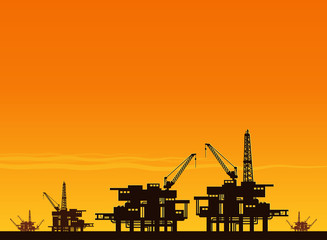 Obraz premium silhouette of working oil pumps on sunset background
