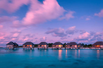 Naklejka premium Wonderful twilight time at tropical beach resort in Maldives