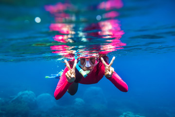 Underwater swimming in blue ocean