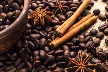 Coffee beans into bowl with cinnamon and anise