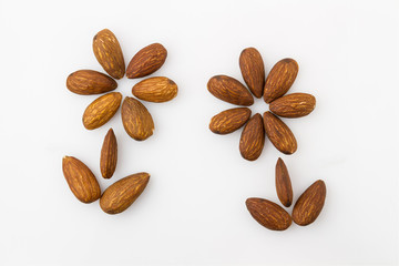Almonds in the shape of a flower on a white background