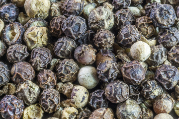 Closeup detail of peppercorns with various textures and colors
