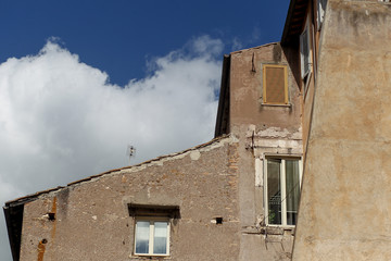 Fototapeta na wymiar Building facade with windows, on blue sky, Rome, Italy
