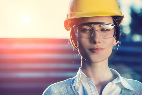 beautiful woman civil engineer close up portrait in front of a sunset background