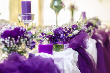 Rich bunch of peonies and tea roses in vase on bride groom table