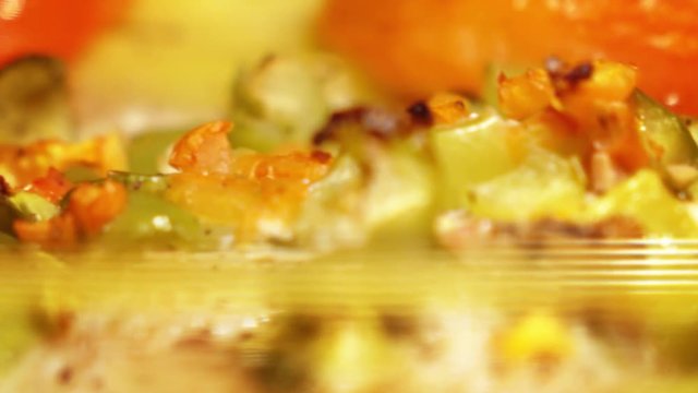 Cooking fish and vegetables in the stove. 4K extreme close-up pan shot