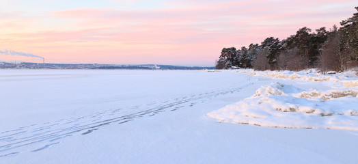 Fototapeta na wymiar Path on the frozen lake on a clear winter morning. Karelia, Russia