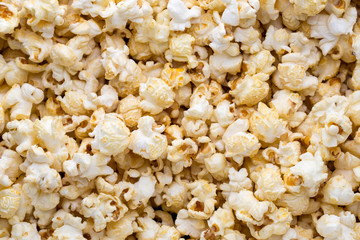 Popcorn background. Caramel sweet corn. Cinema snack.
