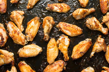 bbq chicken wings on a black plate
