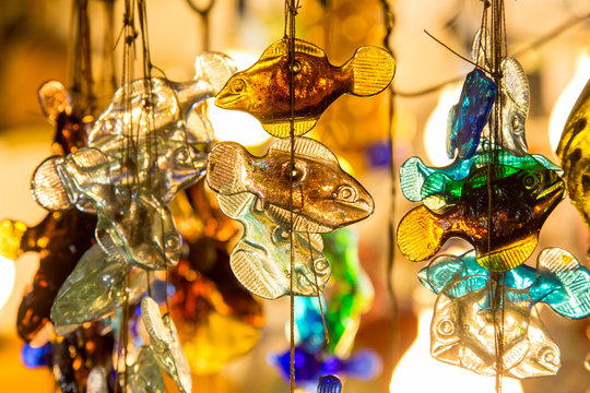 Small decorative glass fishes in a thread