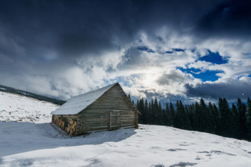 Carpathian mountain village covered with fresh snow. Sunny winte