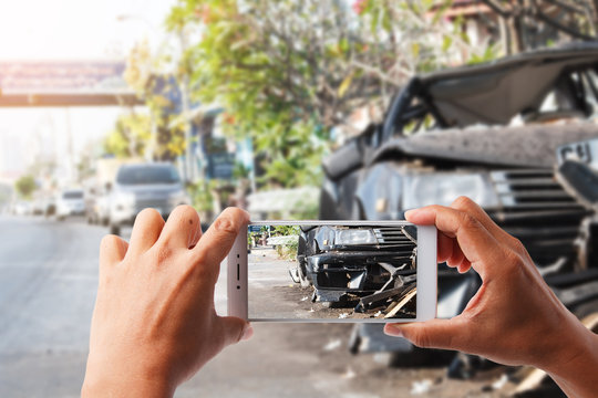 hand holding smartphone and view photo of car accident