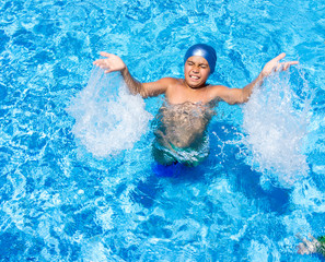 Happy children on summer vacation swimming pool having fun and h