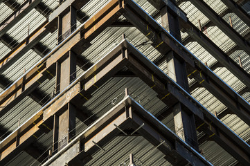 corner detail of high rise building under construction showing steel framework and girders