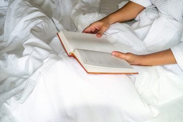 Asian woman reading book on bed © successphoto