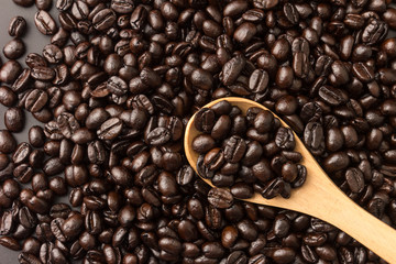 wooden spoon with roasted coffee beans