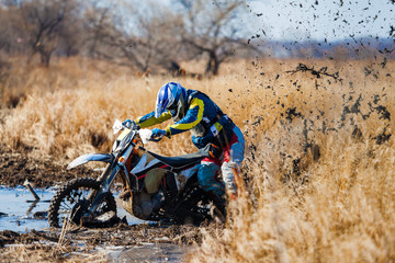 Enduro bike rider stuck in the mud