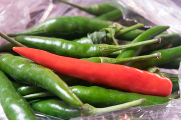 red chili on green chilis