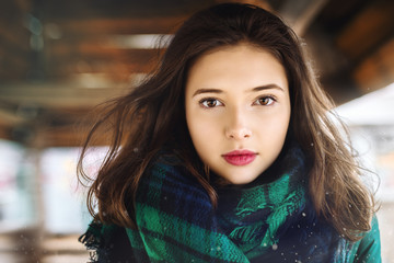 portrait of a beautiful young girl on the street in winter