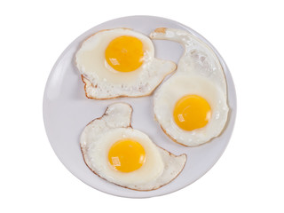 Tree sunny side up eggs on plate isolated