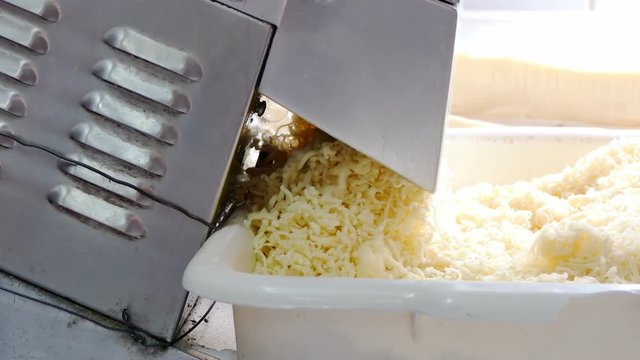 Process of making cheese in a factory. Close up. slice cheese machine 