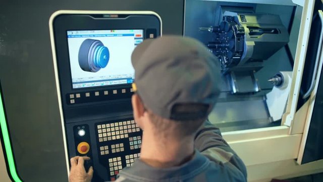 Industrial engineer worker operating control panel system at manufacture plant