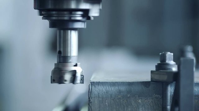 CNC milling machine produces metal detail on factory