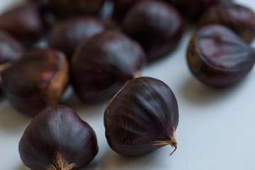 Chestnut fruits on light background selective focus
