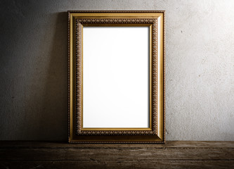 luxurious photo frame on wooden table over grunge background