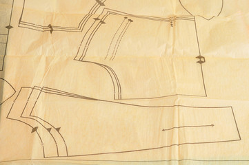 A piece of wrinkled paper with a pattern for making clothes