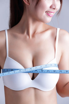 young woman checking breast measurement