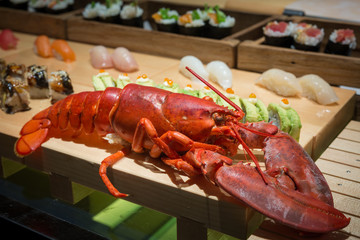 close up of big lobster on wood tray