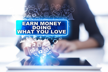 Fototapeta na wymiar Woman is using tablet pc, pressing on virtual screen and selecting earn money doing what you love.