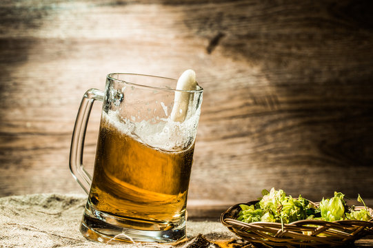 Beer in tankard close-up stands on linen cloth