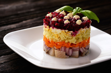 Russian salad with vegetables and herring.