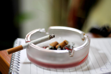 Dirty Ashtray and Cigarette Closeup Isolated