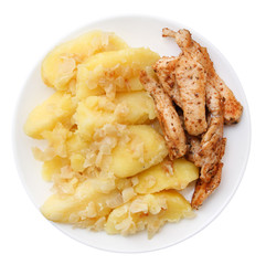 Roast pork and potatoes on a plate isolated with clipping path.